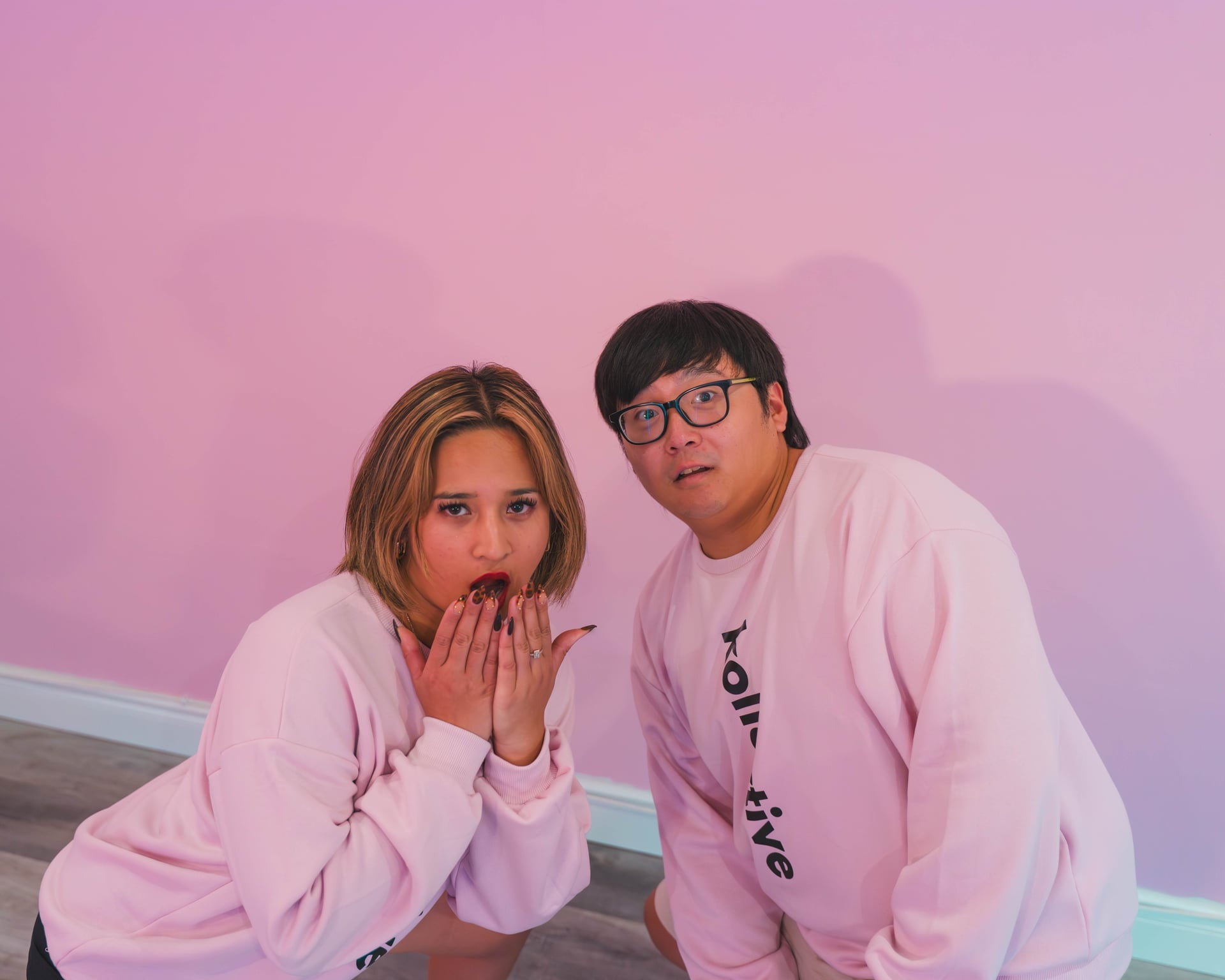 Kollective Studios team in pink hoodies